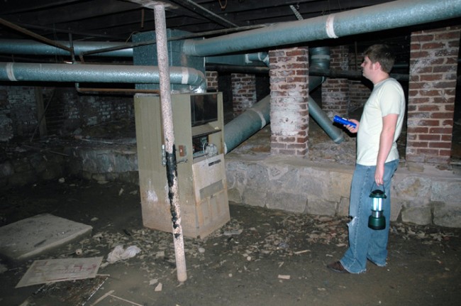 Crawl space with pre-historic heater.