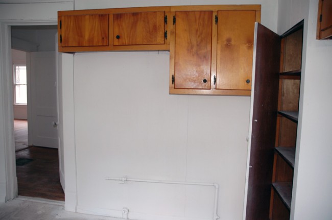 Cabinets and door to hallway.