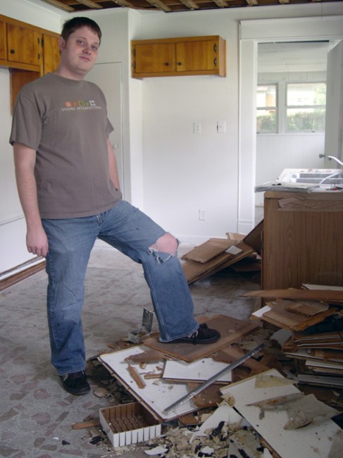 Patrick proudly showing off the pile of drop-ceiling.