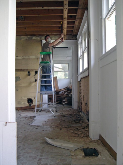 Half-way through removing the drop-ceiling beams...or so he thought...