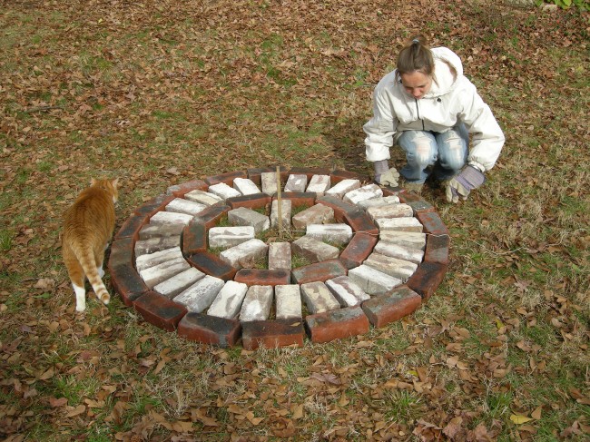 Steffi laying out the bricks to create the pattern for the patio.